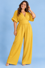 Combinaison pantalon jaune à col V et jambes larges | Porté sur une silhouette plus ronde | Lounelle Paris